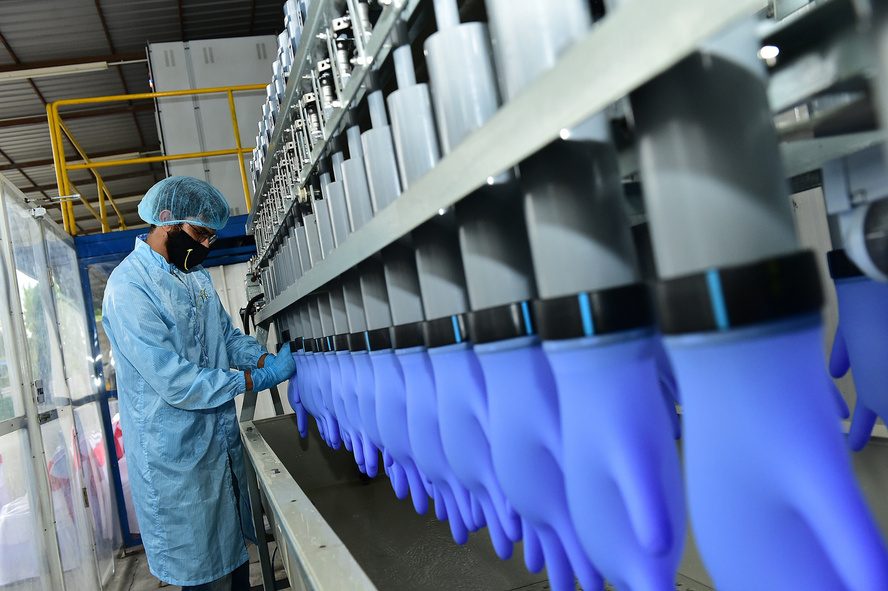 Gloves undergoing water-fill pinhole leak testing