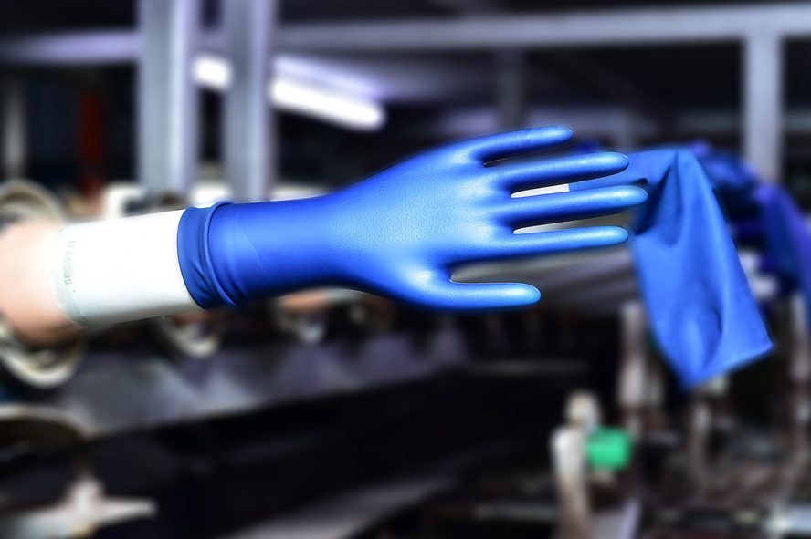 Blue chemotherapy examination glove on dipping former