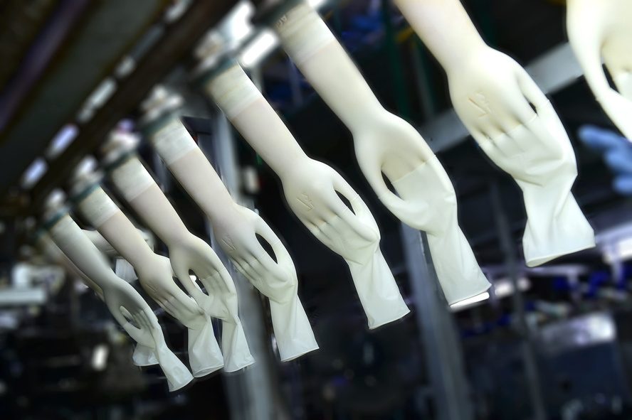 White sterile surgical gloves on production formers