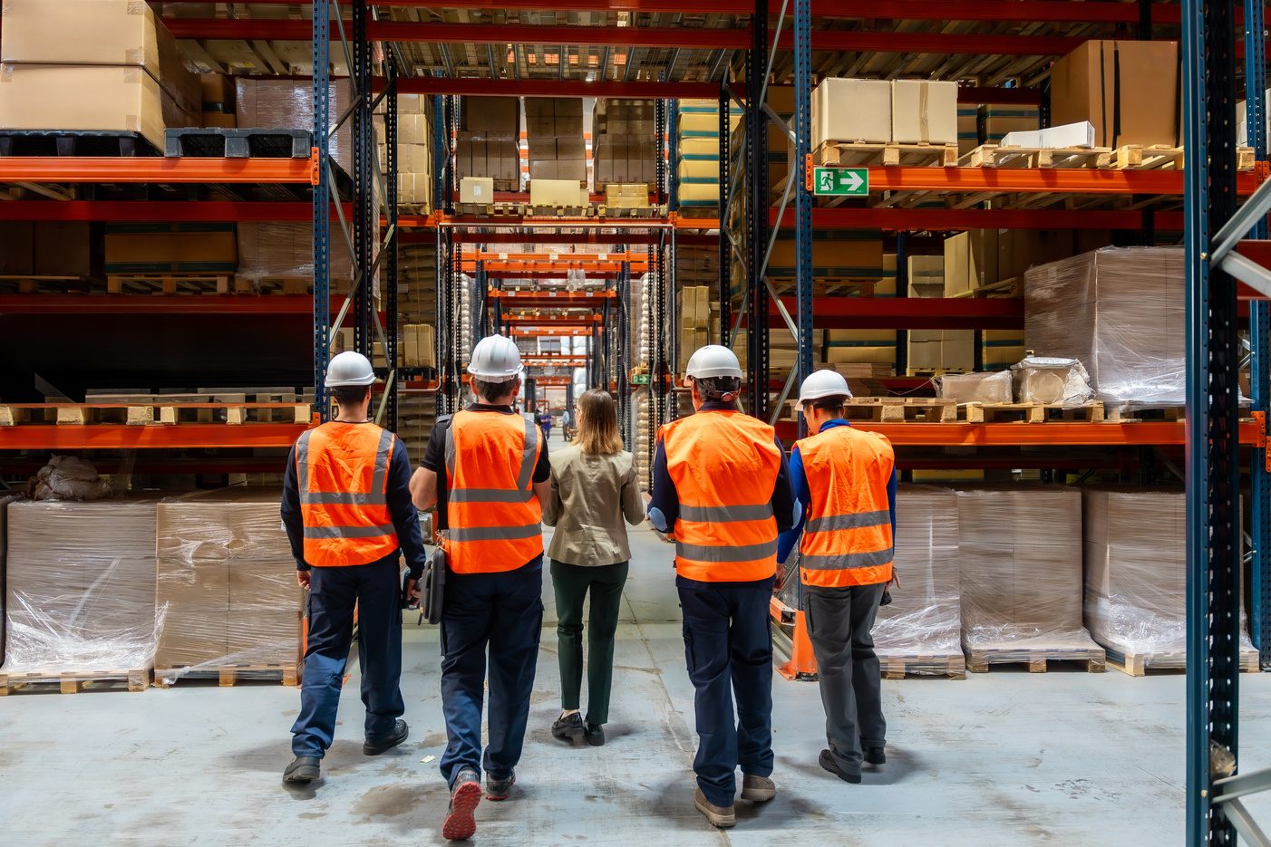 Premium Health Care logistics team walking through a glove distribution warehouse